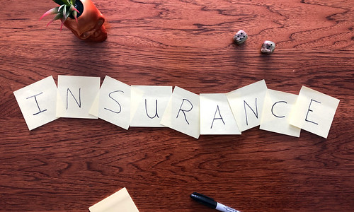 The Word 'Insurance' Spelled Out Letter By Letter on Post-It Notes with a Permanent Marker