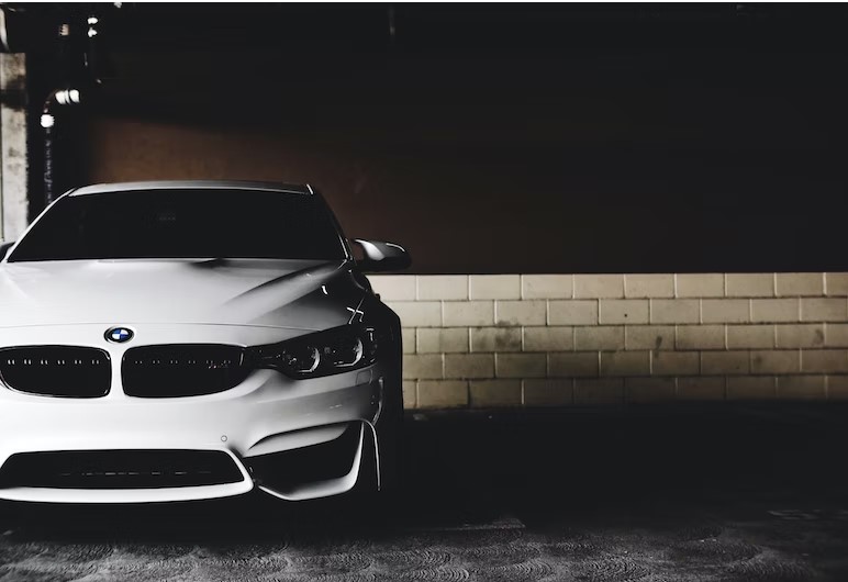 White painted BMW car in parking garage.