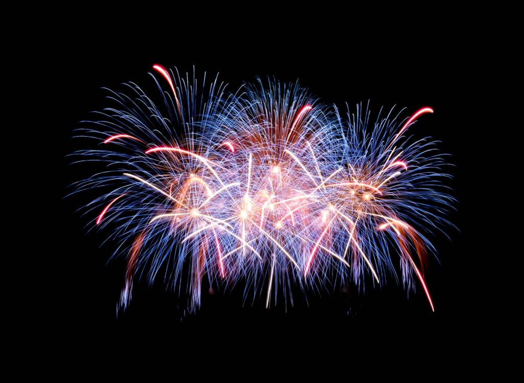 A red, white, and blue fireworks display above Chicago, IL