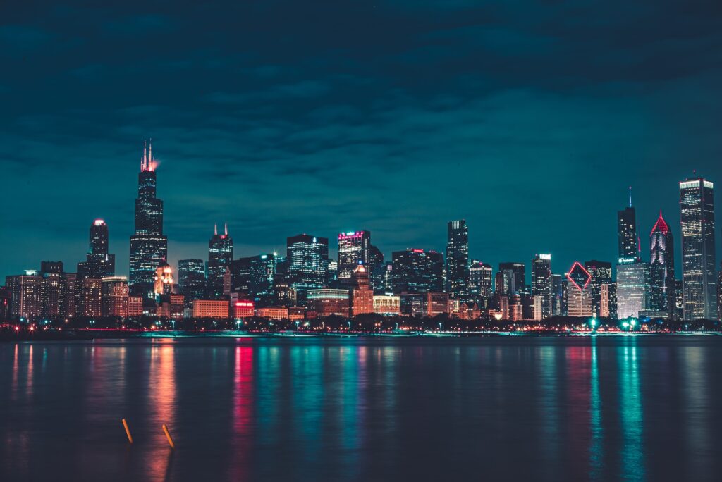 The Chicago skyline, lit up at night during a holiday season.