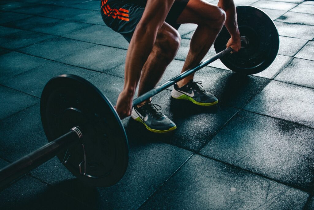 A person about to lift a large dumbbell at a gym in Chicago, IL