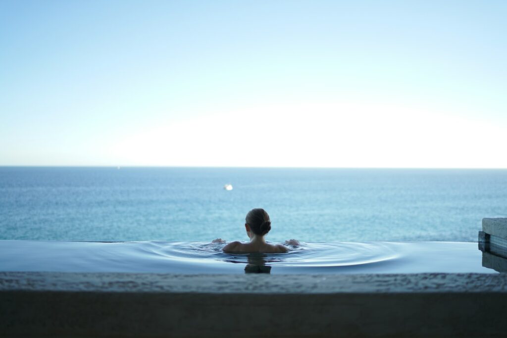 A pool at a spa looking out over the lake.