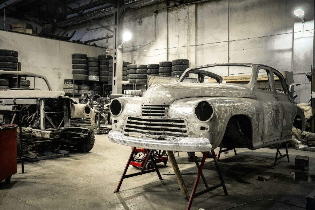 2 raised cars inside of an auto body shop in Chicago.