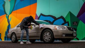 man waxing used car