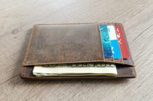 Wallet on a table with money and credit cards showing
